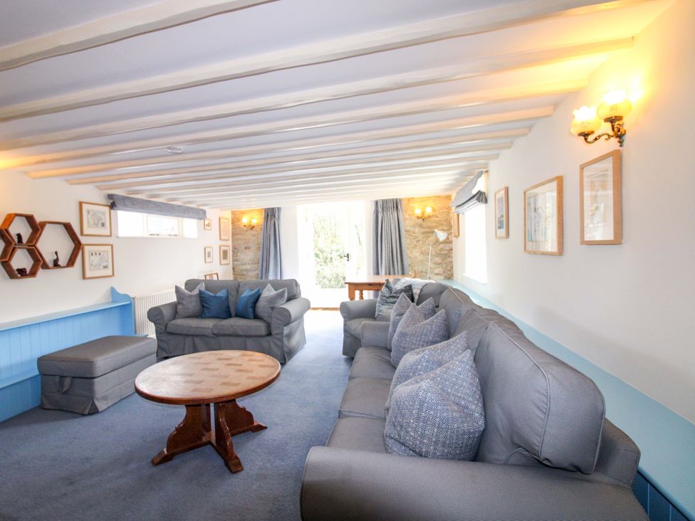 A living room with a sofa and coffee table at Orchard Barn Salcombe