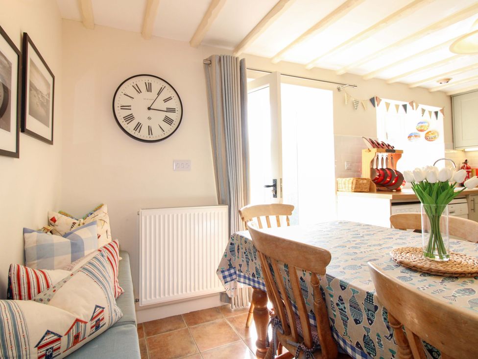 A dining room with a table and chairs at Orchard Barn Salcombe