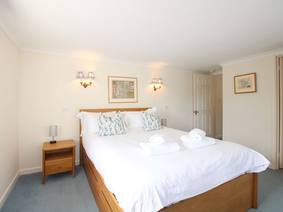 A bedroom with a double bed and nightstand at Orchard Barn Salcombe