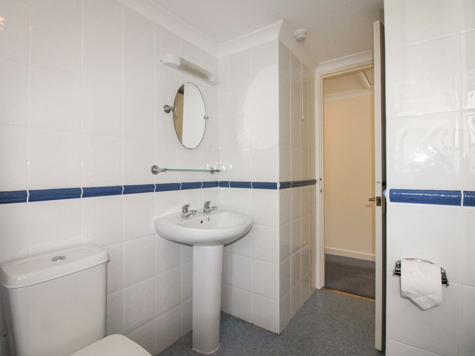 A bathroom with a sink and toilet at Orchard Barn Salcombe