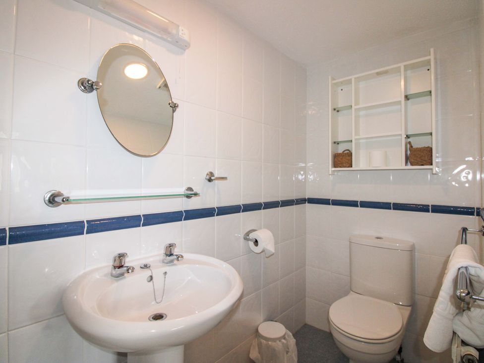 A bathroom with a sink and toilet at Orchard Barn Salcombe