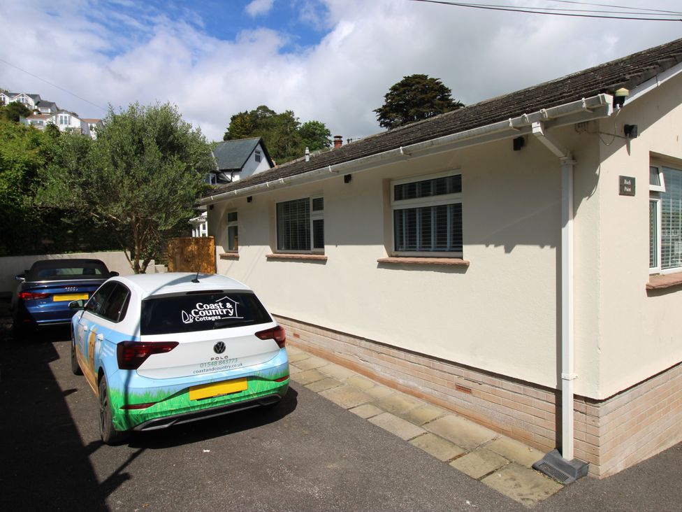 A house with two cars parked in front at Rock Point in Salcombe