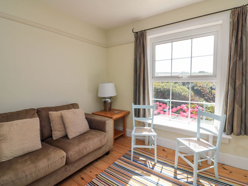 A snug with a sofa and two chairs at Savernake in Thurlestone