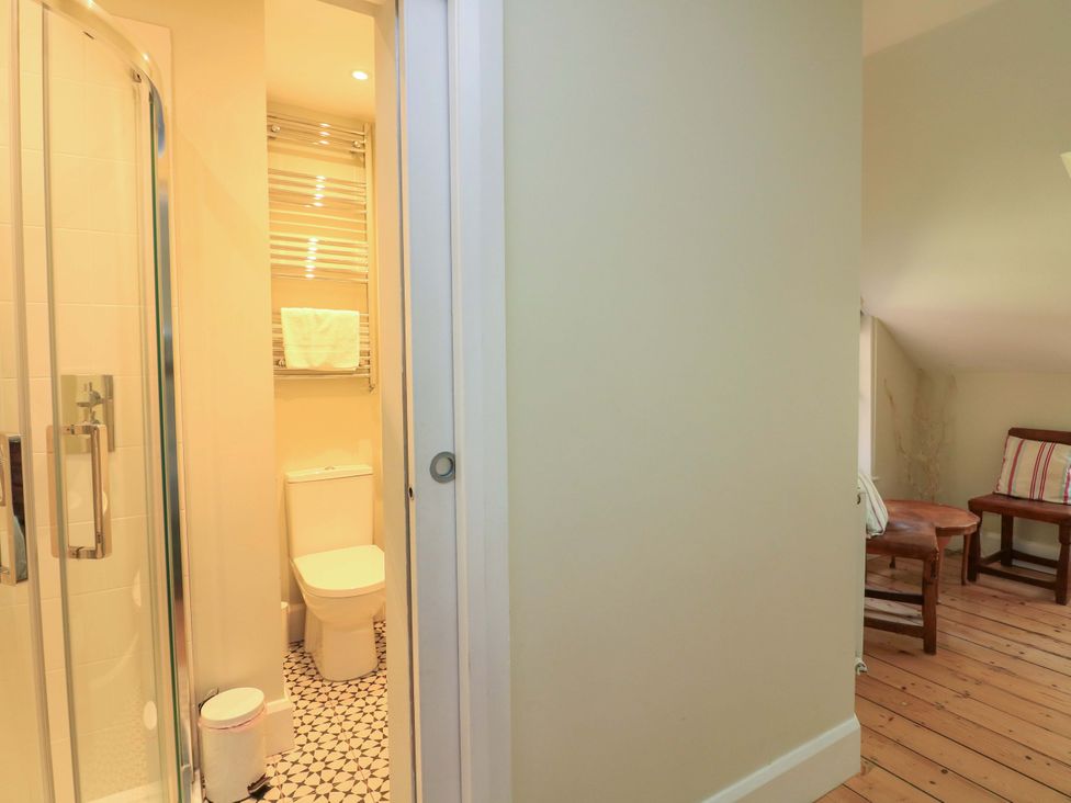 A bathroom with a shower and toilet at Savernake in Thurlestone