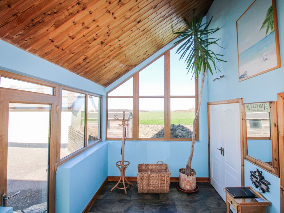 An entrance hall with a coat rack and plant at The Station in Bolberry