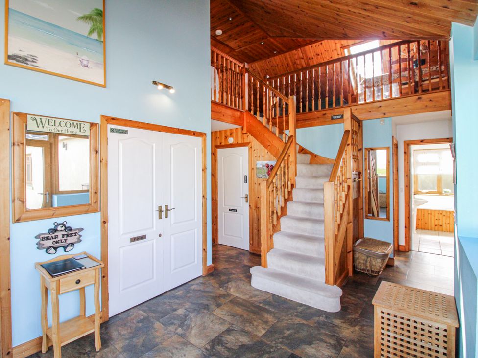 A hallway with stairs and mirrors at The Station in Bolberry