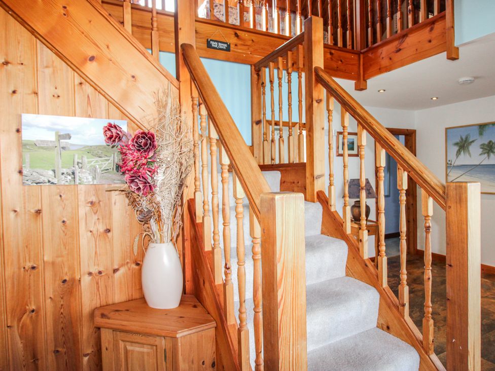 An entryway with stairs and a vase of flowers at The Station in Bolberry