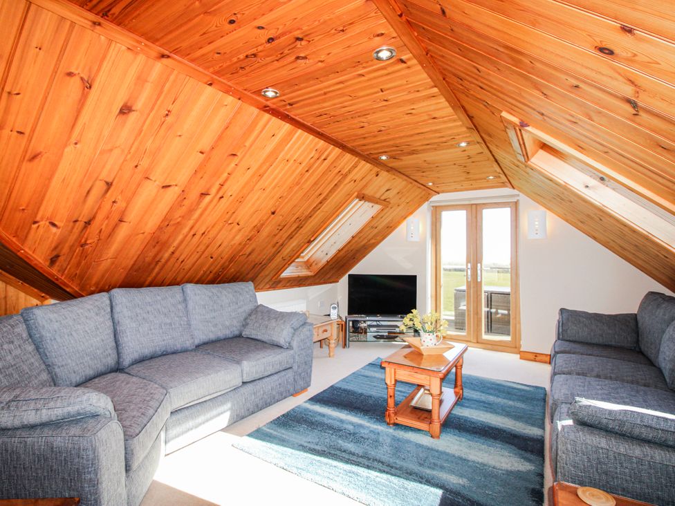 A living room with two sofas and a television at The Station in Bolberry