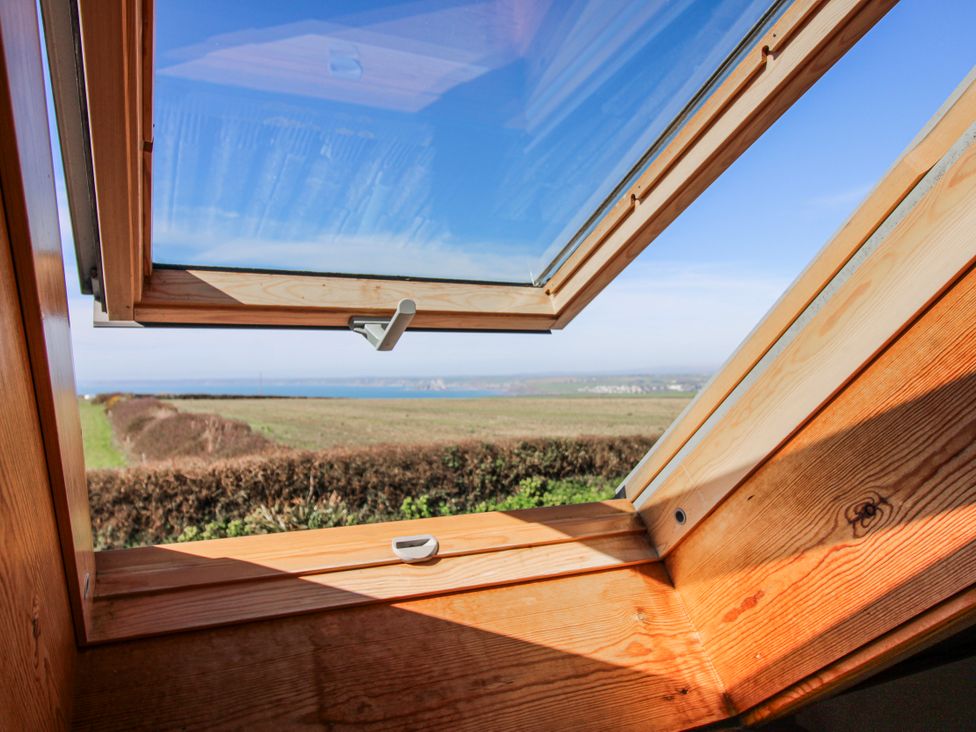 A window view of the countryside and water at The Station in Bolberry