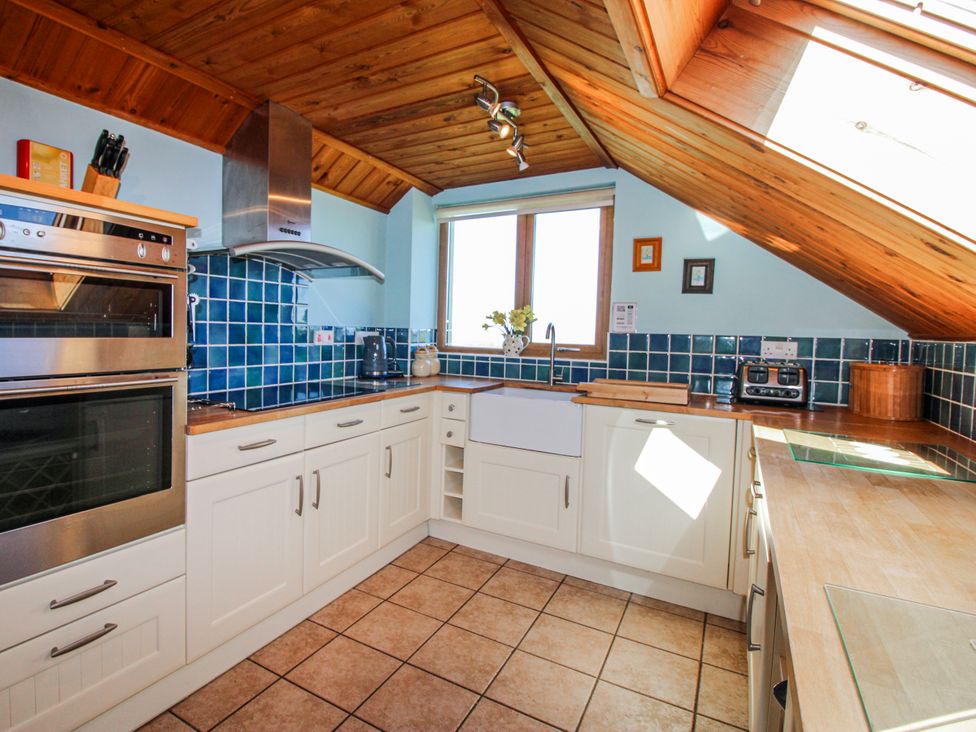A kitchen with a sink, oven, and countertop at The Station in Bolberry