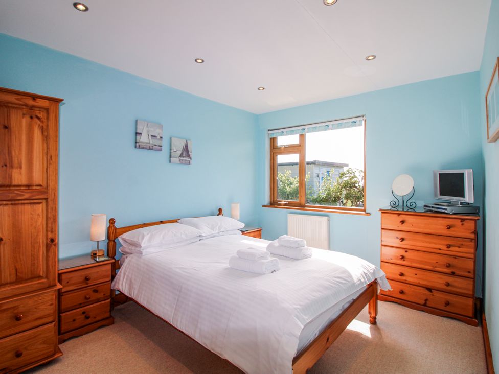 A bedroom with a bed and dresser at The Station in Bolberry