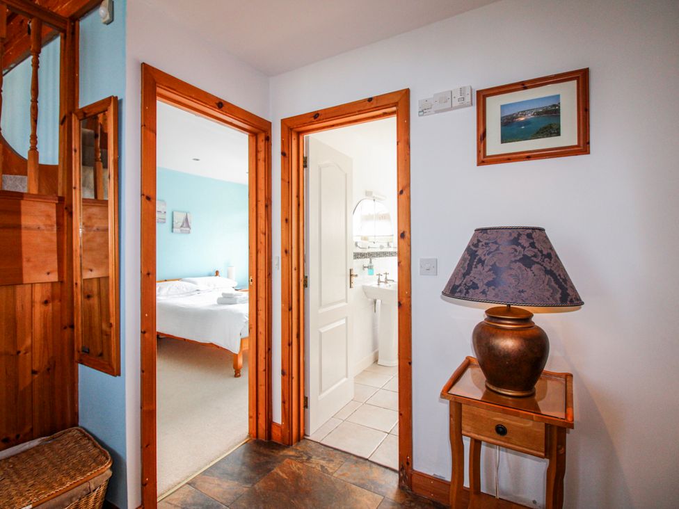 A hallway with a lamp and basket at The Station in Bolberry