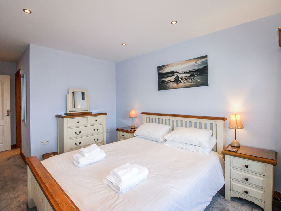 A bedroom with a bed and nightstands at The Station in Bolberry
