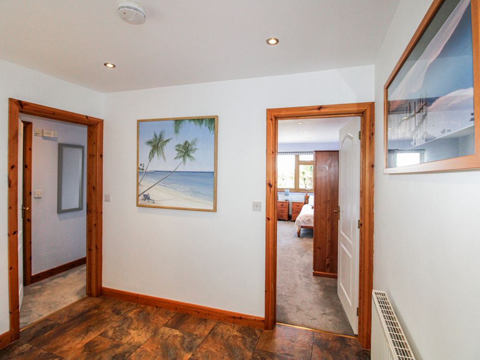 A hallway with a painting and doors at The Station in Bolberry