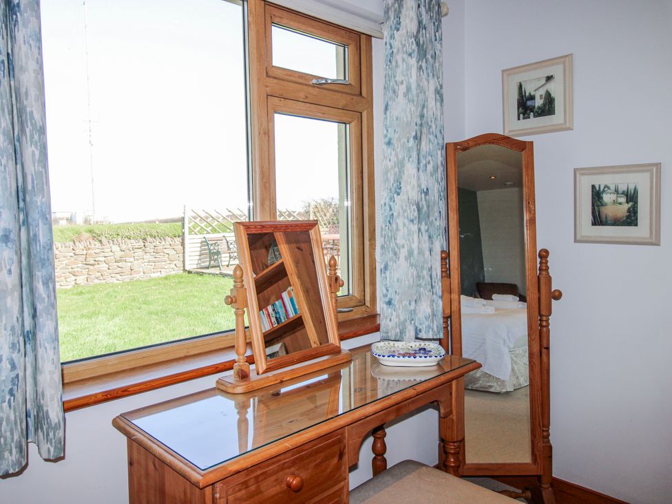 A bedroom with a desk and mirror at The Station in Bolberry