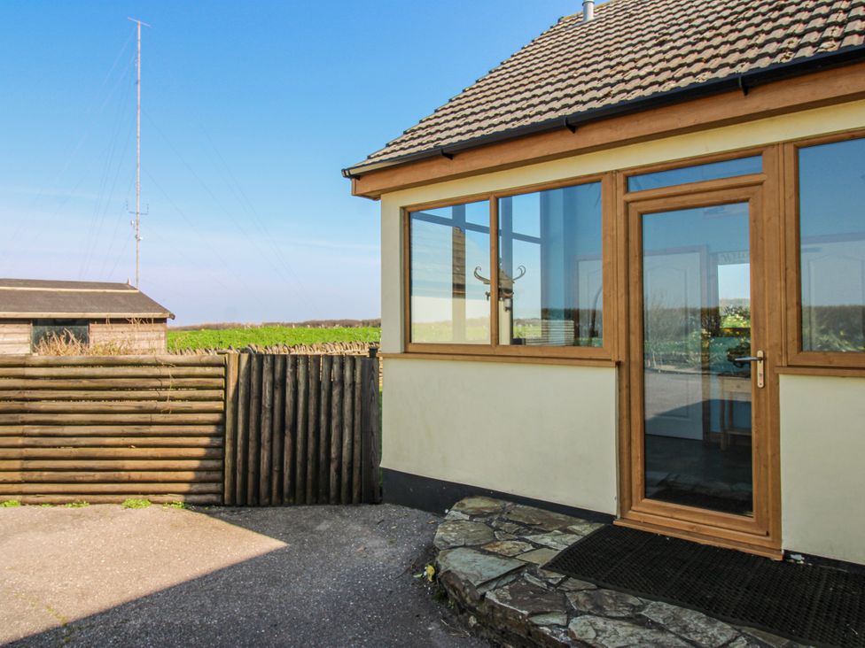 An outdoor area with a wooden door and fence at The Station in Bolberry