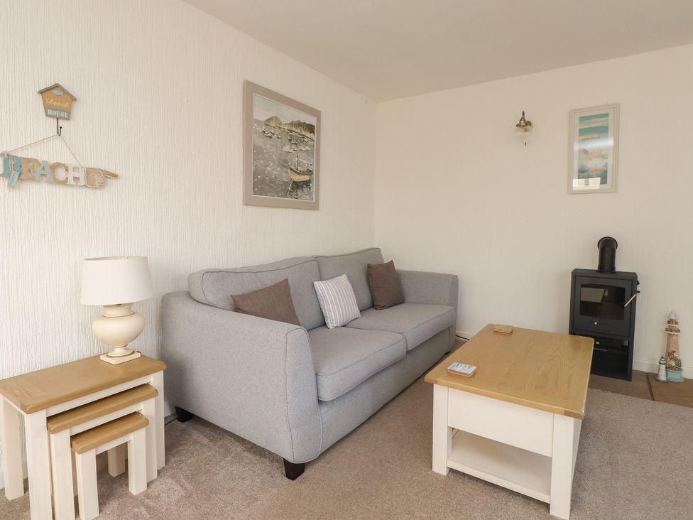 A living room with a sofa and a coffee table at Maes Y Coed Morfa Nefyn