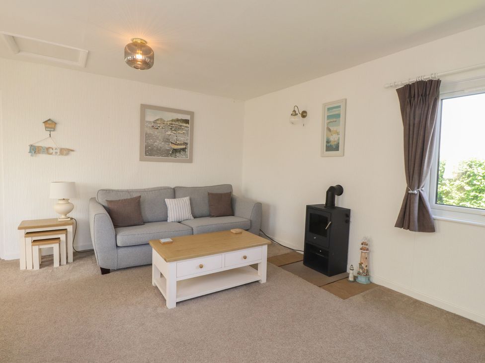 A living room with a sofa and coffee table at Maes Y Coed in Morfa Nefyn
