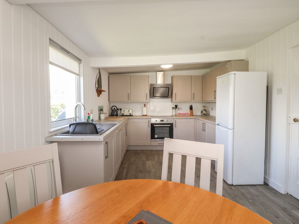 A kitchen with cabinets and appliances at Maes Y Coed in Morfa Nefyn
