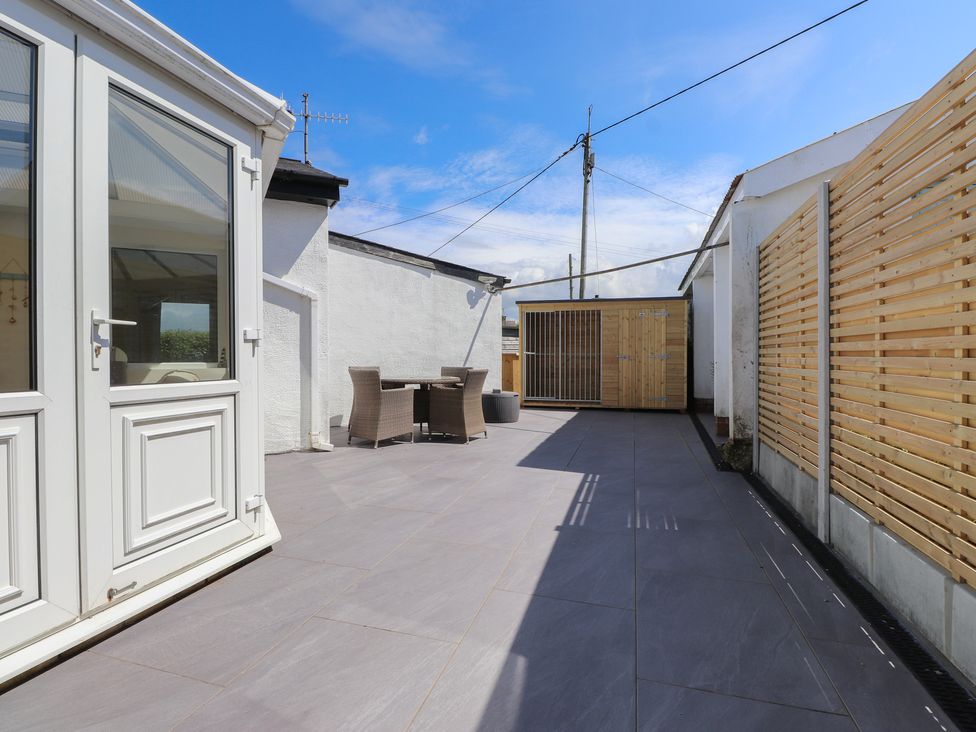 An outdoor area with seating and a shed at Maes Y Coed Morfa Nefyn