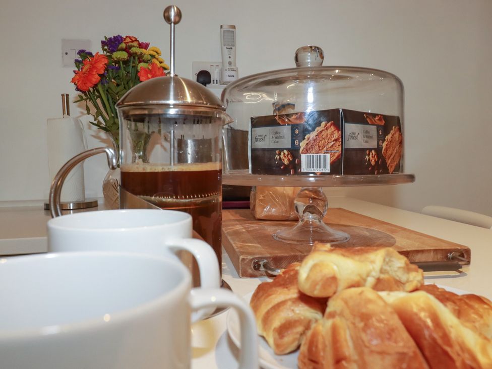 A kitchen with croissants and coffee at Rock House Trebarwith Strand near Tintagel