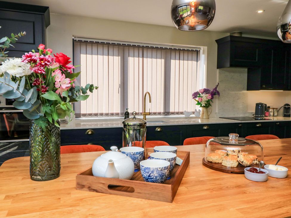 A kitchen with a table and tea set at The Old Dairy Cotleigh near Honiton