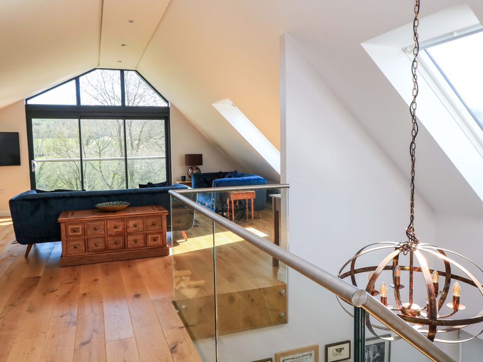 A living room with a sofa and coffee table at The Old Dairy in Cotleigh near Honiton