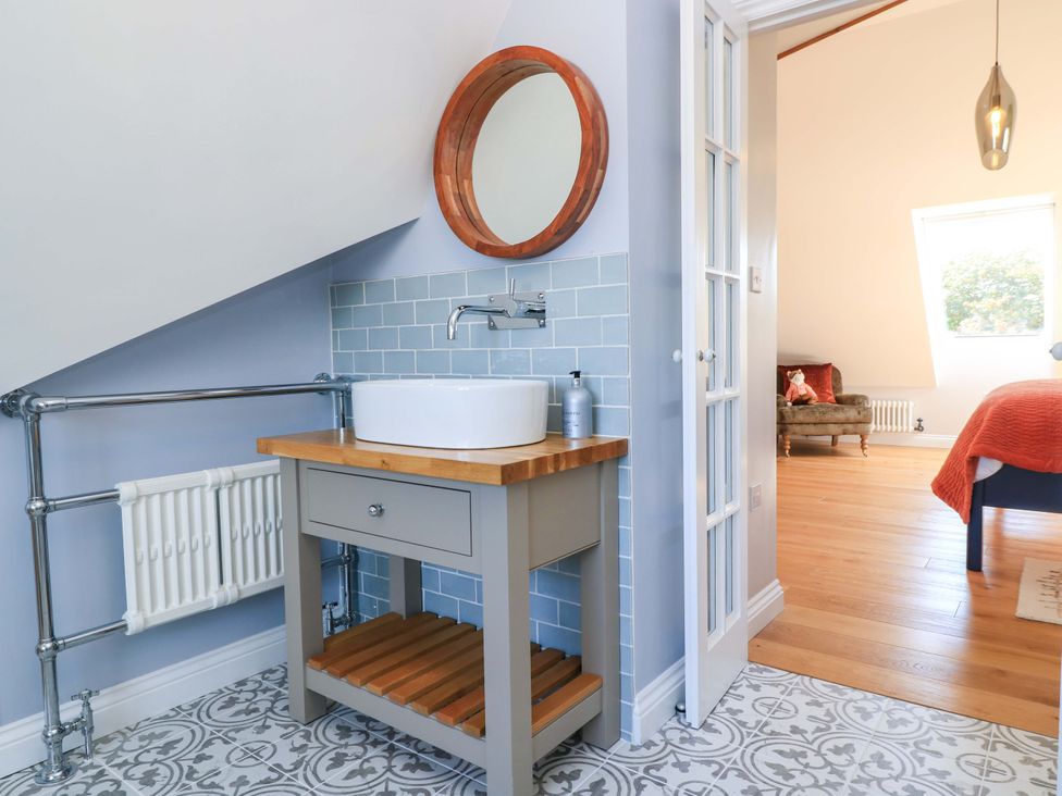A bathroom with a sink and mirror at The Old Dairy Cotleigh near Honiton