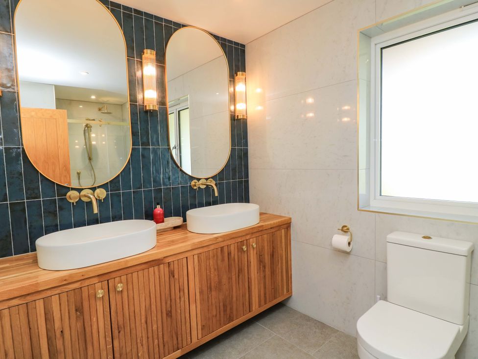 A bathroom with sinks and mirrors at The Old Dairy Cotleigh near Honiton