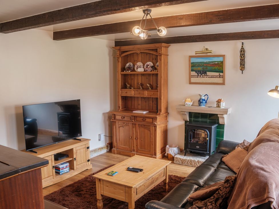 A living room with a television and a coffee table at Shires Rest Hartington