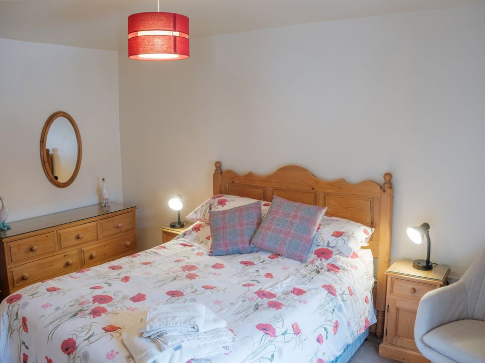 A bedroom with a bed and dresser at Shires Rest in Hartington