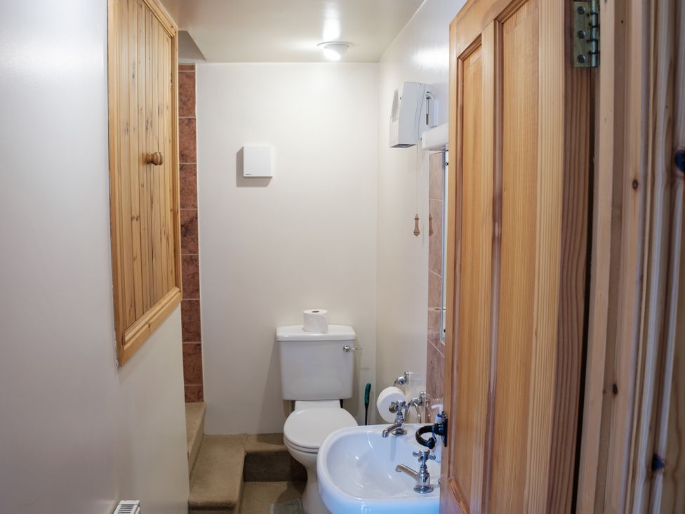 A bathroom with a toilet and sink at Shires Rest in Hartington