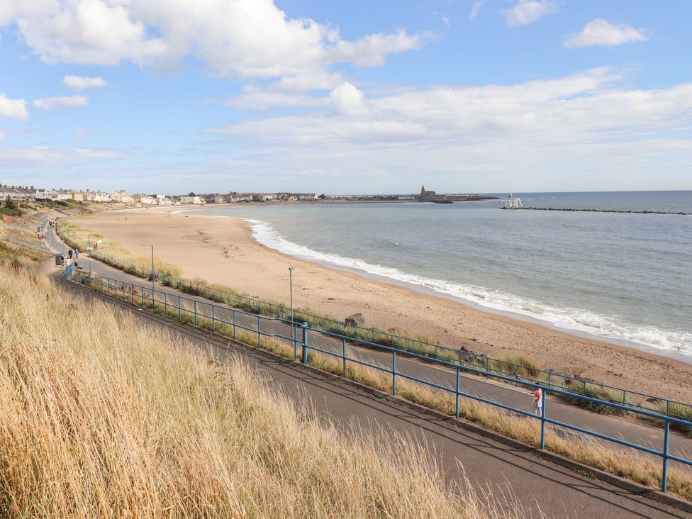 A beach with a pathway and sea view at Beach Cove View in Newbiggin-by-the-Sea