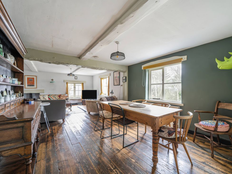 A dining room with a table and chairs at Spring Park Farmhouse in Launceston