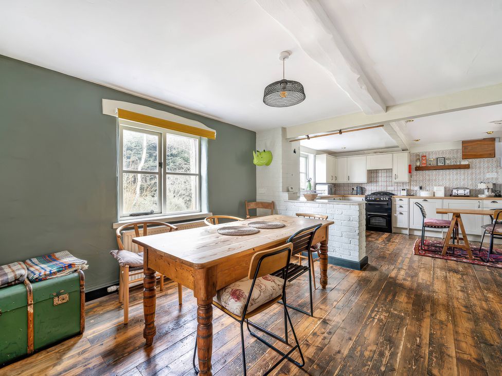 A kitchen with a dining table and chairs at Spring Park Farmhouse in Launceston