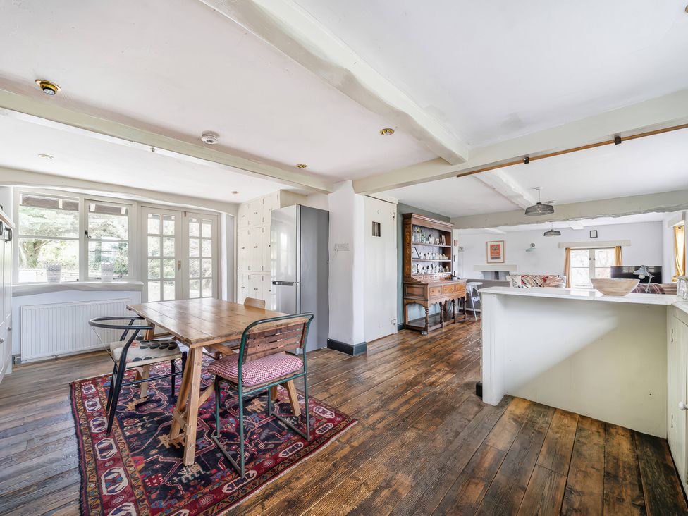 A dining room with a table and chairs at Spring Park Farmhouse in Launceston