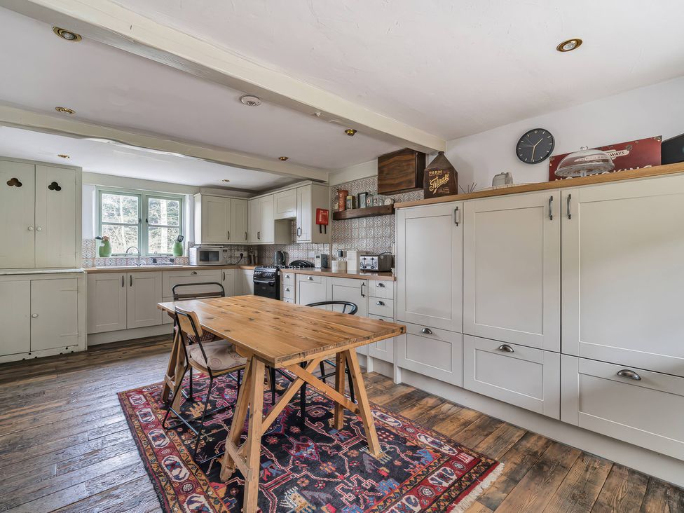 A kitchen with a table and chairs at Spring Park Farmhouse in Launceston