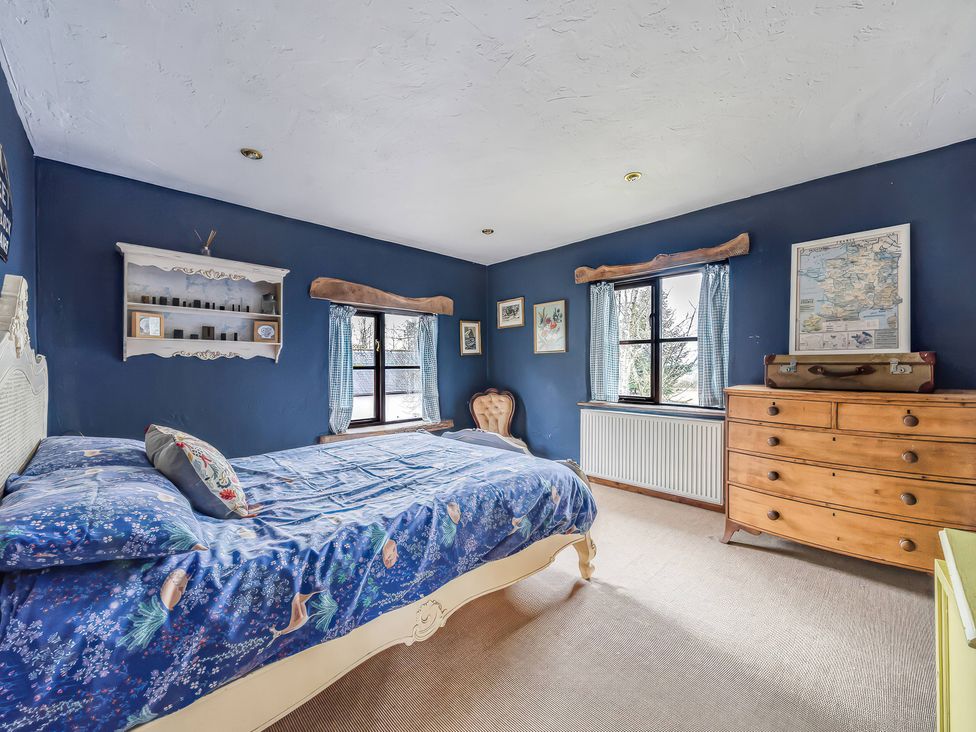 A bedroom with a bed and a shelf at Spring Park Farmhouse in Launceston