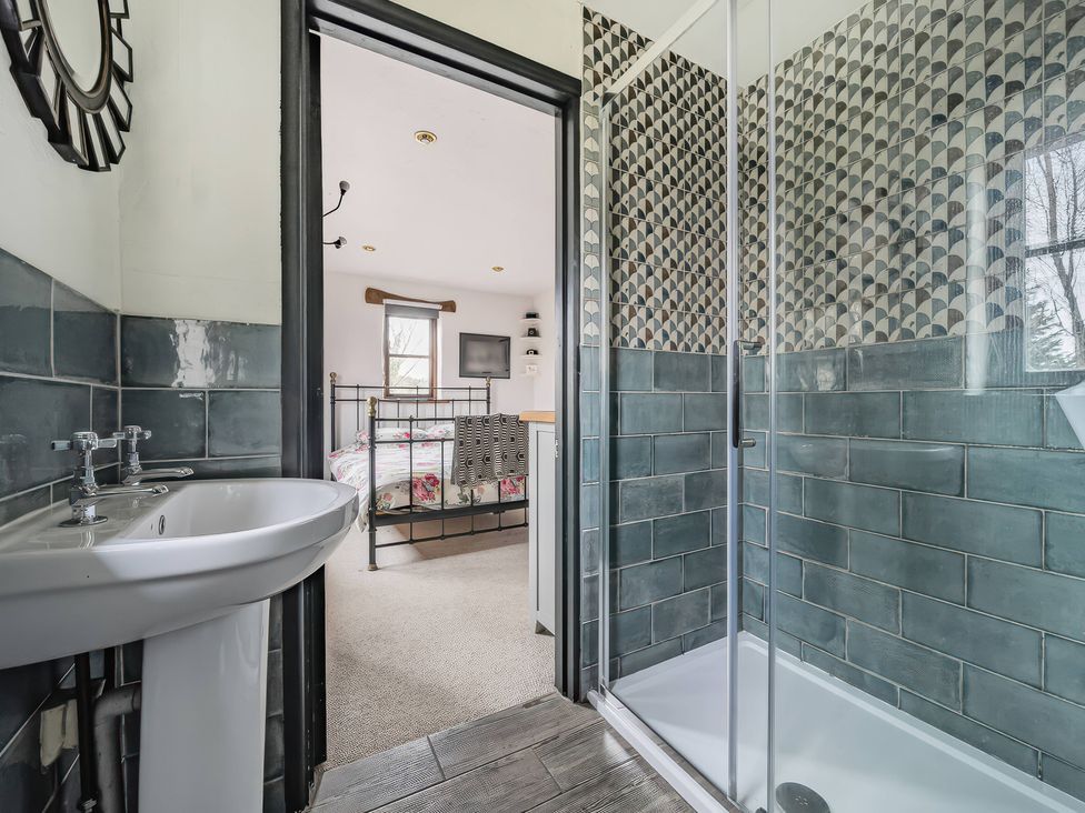 A bathroom with a sink and shower at Spring Park Farmhouse in Launceston