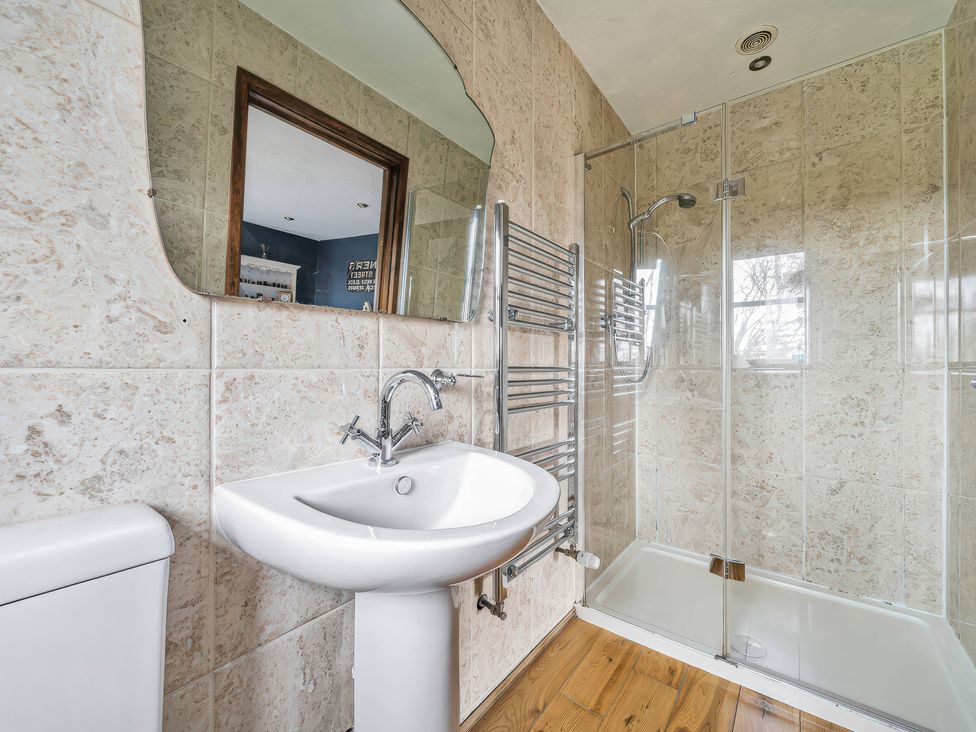 A bathroom with a shower and sink at Spring Park Farmhouse in Launceston