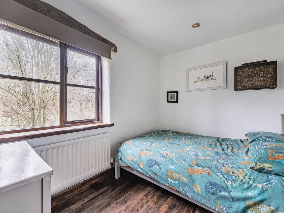 A bedroom with a bed and window at Spring Park Farmhouse in Launceston