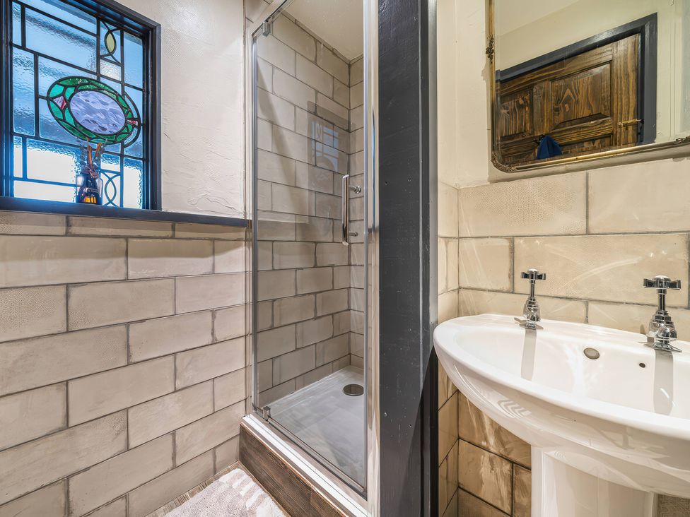 A bathroom with a shower and sink at Spring Park Farmhouse in Launceston