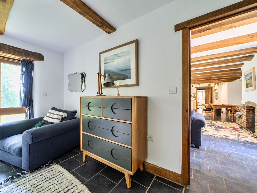 A living room with a sofa and chest of drawers at Woodcutters in Rezare near Launceston