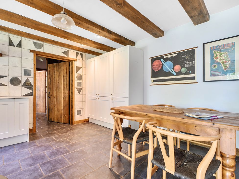 A kitchen with a table and chairs at Woodcutters in Rezare near Launceston
