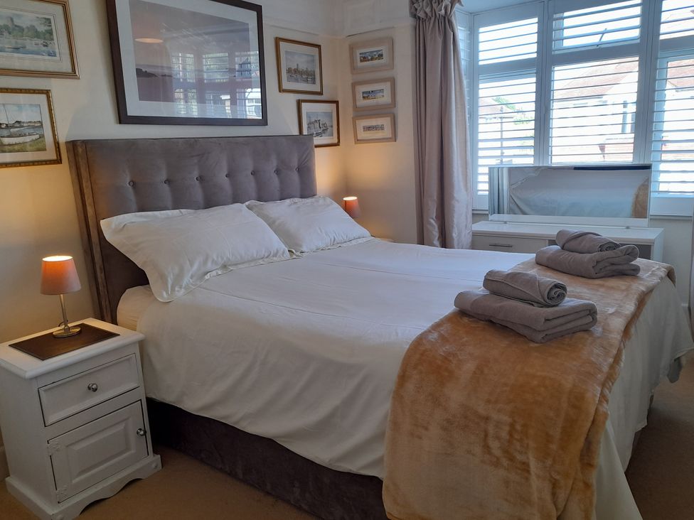 A bedroom with a bed and bedside table at 32 Cranleigh Close Tuckton