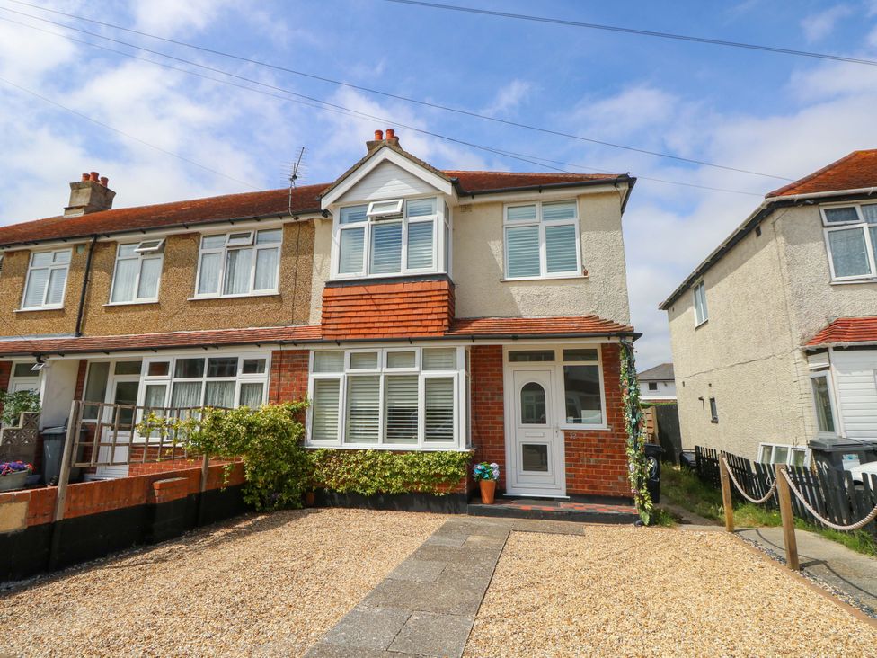 A house with a gravel driveway and plants at 32 Cranleigh Close in Tuckton