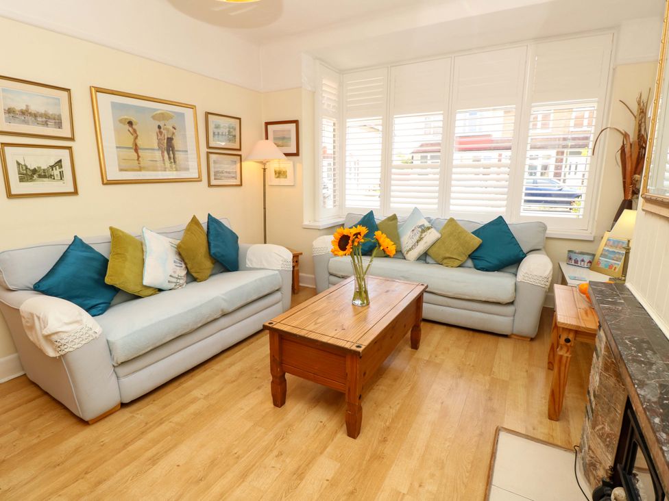 A living room with a coffee table and sofas at 32 Cranleigh Close Tuckton