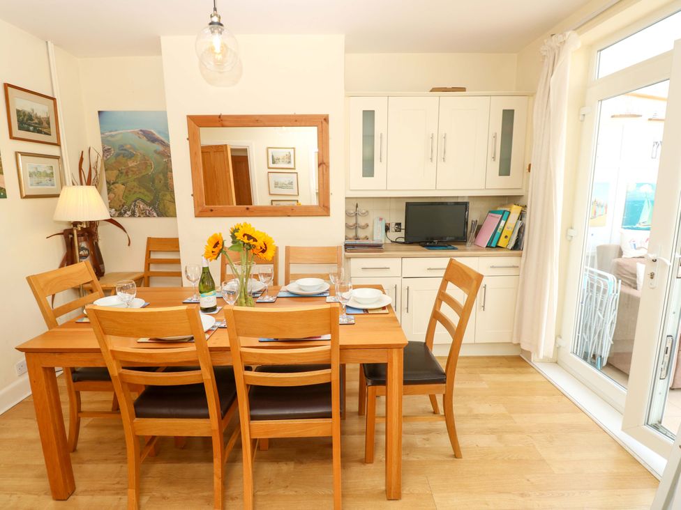 A dining room with a table set for dinner at 32 Cranleigh Close Tuckton
