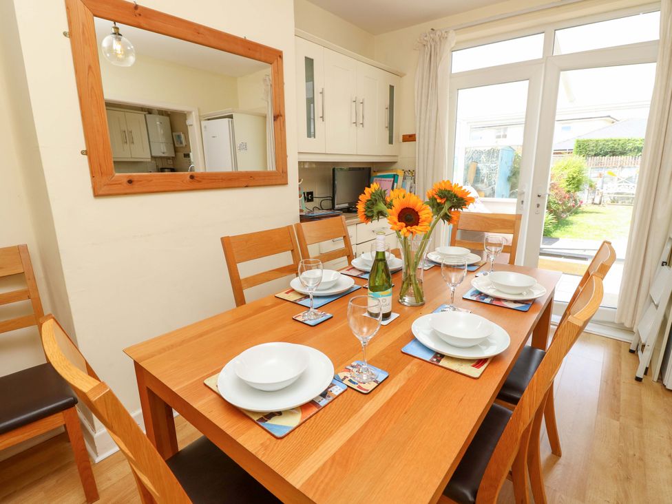 A dining room with a table set for a meal at 32 Cranleigh Close Tuckton
