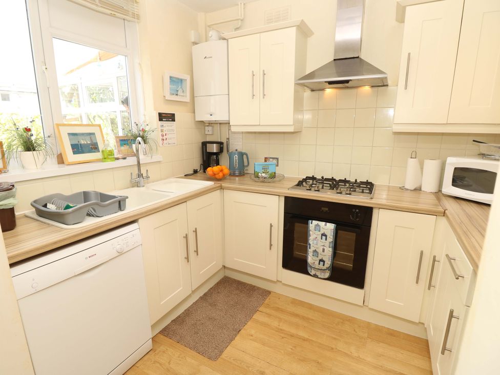 A kitchen with appliances and sink at 32 Cranleigh Close Tuckton